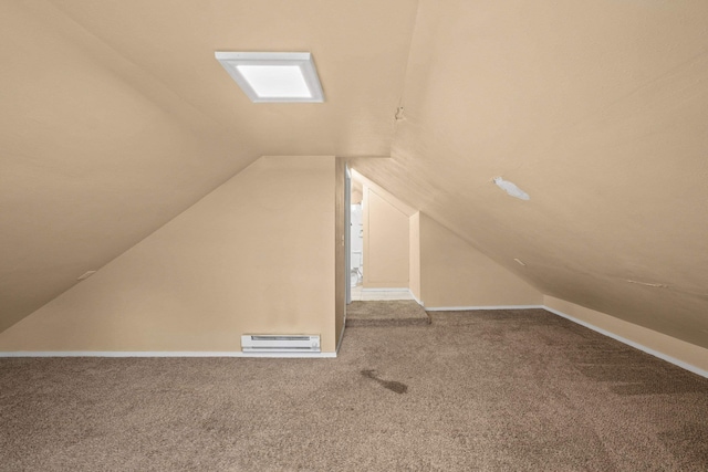 additional living space featuring lofted ceiling, a baseboard heating unit, carpet, and baseboards