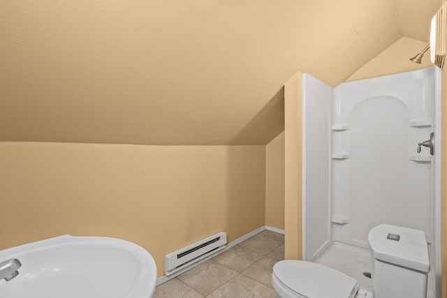 bathroom with tile patterned flooring, toilet, a sink, vaulted ceiling, and baseboard heating