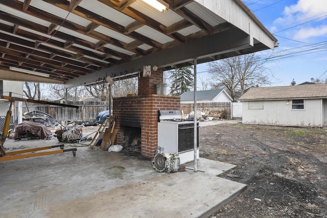 view of patio / terrace with a carport and a fenced backyard