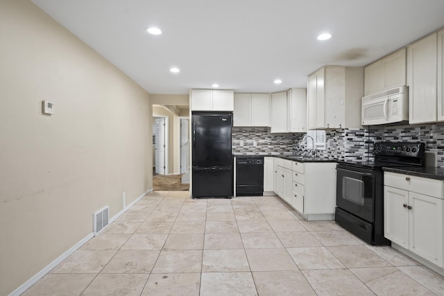 kitchen with tasteful backsplash, dark countertops, visible vents, light tile patterned flooring, and black appliances