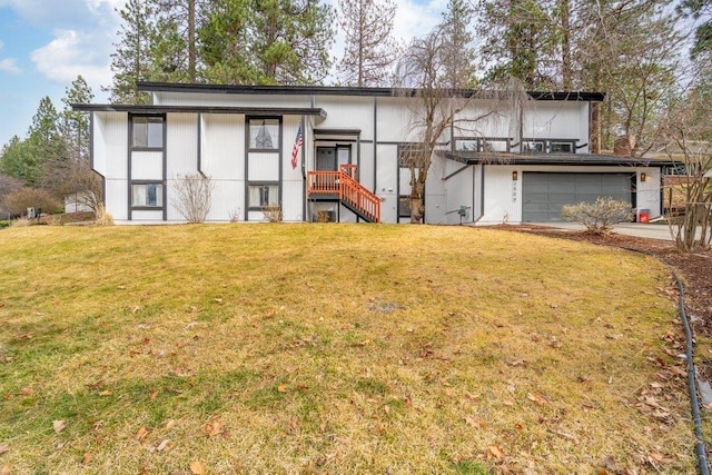 view of front of property with a garage, driveway, and a front yard