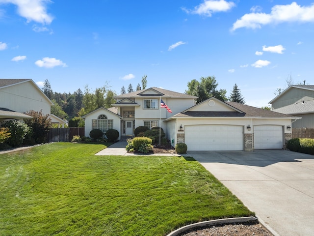 view of front of home featuring a garage, a front yard, concrete driveway, and fence