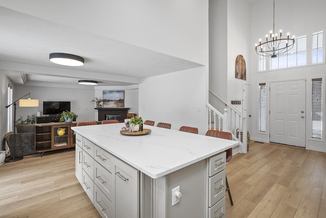 kitchen featuring open floor plan, light wood-type flooring, and a healthy amount of sunlight