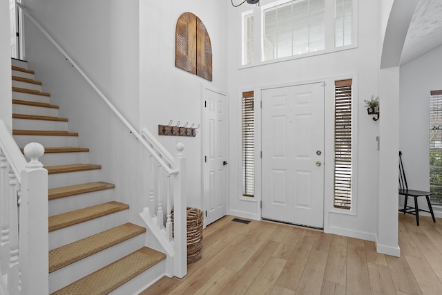 foyer entrance featuring a wealth of natural light and light wood-style flooring