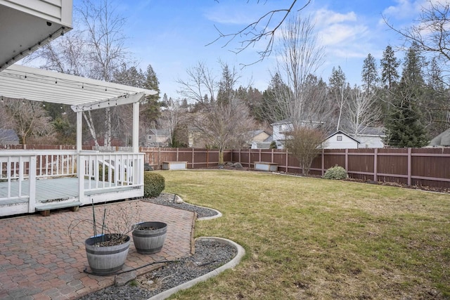 view of yard featuring a patio area, a fenced backyard, and a wooden deck