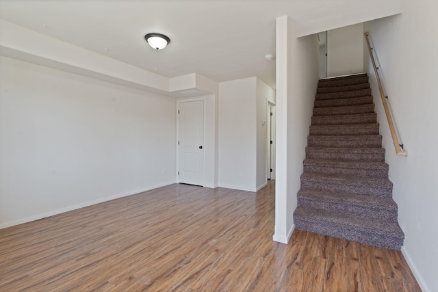 stairs with baseboards and wood finished floors