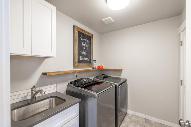 laundry room featuring cabinet space, visible vents, independent washer and dryer, a sink, and light tile patterned flooring