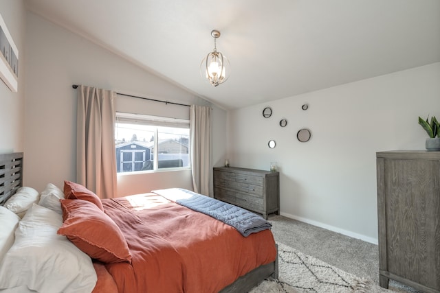 bedroom featuring carpet floors, lofted ceiling, baseboards, and an inviting chandelier