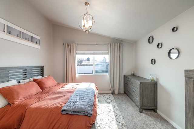 bedroom featuring light carpet, vaulted ceiling, an inviting chandelier, and baseboards