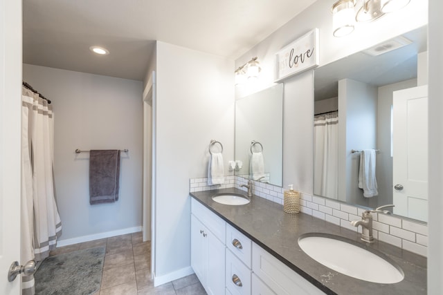 full bathroom with tile patterned floors, a sink, backsplash, and double vanity