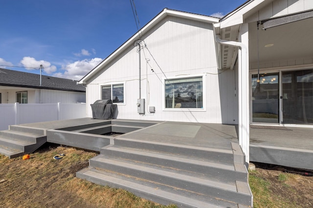 view of exterior entry with a deck