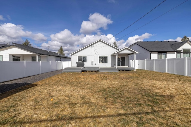 back of house featuring a fenced backyard and a yard