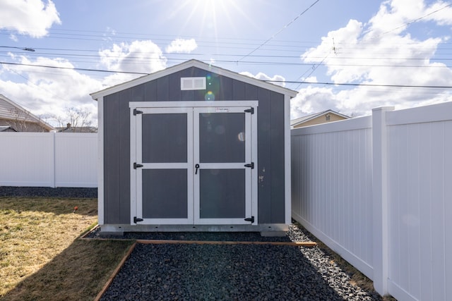 view of shed featuring a fenced backyard