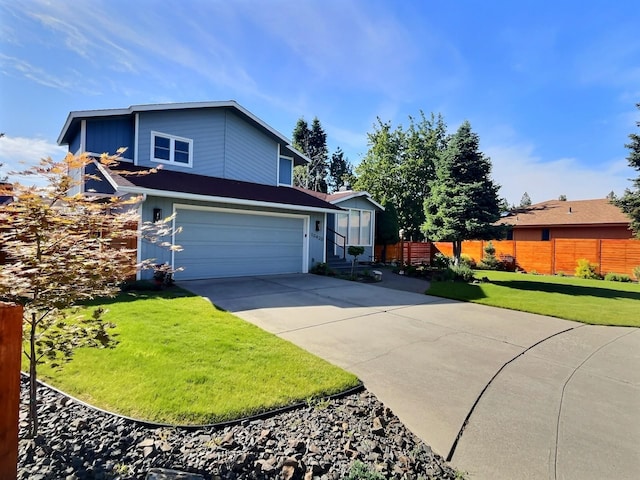 traditional-style house featuring a garage, fence, a front lawn, and concrete driveway