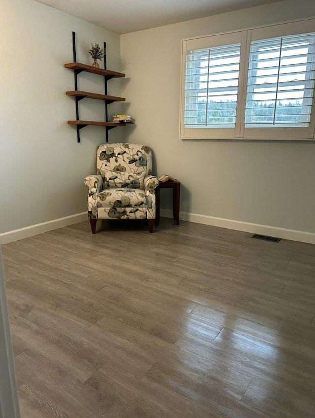 unfurnished room with visible vents, baseboards, and wood finished floors