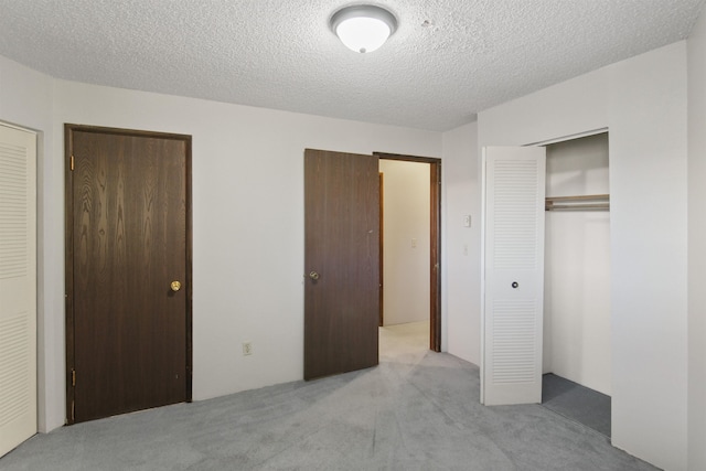 unfurnished bedroom with carpet floors and a textured ceiling