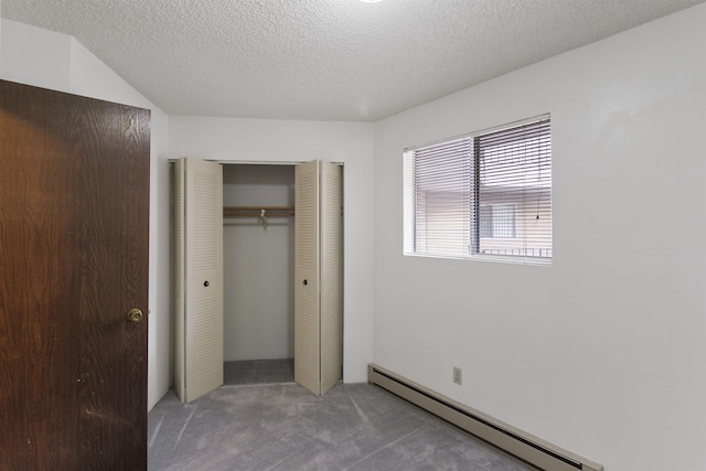 unfurnished bedroom featuring carpet floors, a closet, a textured ceiling, and baseboard heating