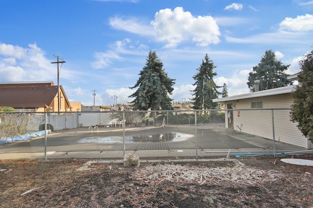 view of yard featuring a patio area, fence, and a community pool