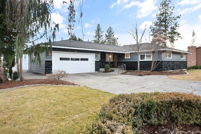 ranch-style home featuring stone siding, concrete driveway, an attached garage, and a front yard