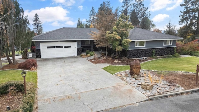 ranch-style house with a garage, driveway, stone siding, roof with shingles, and a front lawn