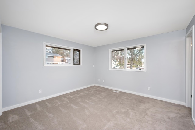 carpeted spare room with baseboards