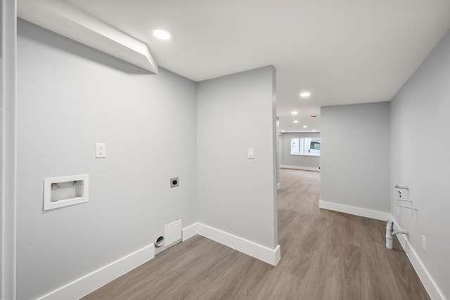 clothes washing area featuring hookup for a washing machine, hookup for an electric dryer, baseboards, and wood finished floors