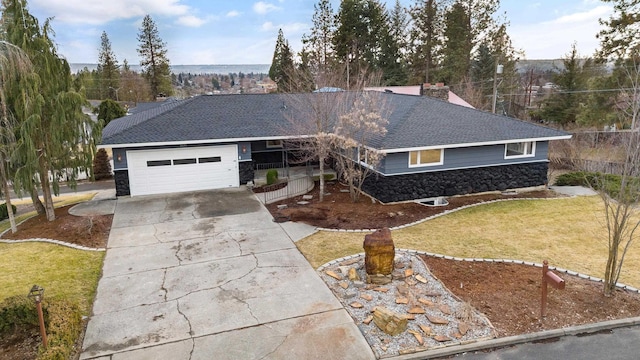 single story home with roof with shingles, a chimney, an attached garage, a front yard, and driveway