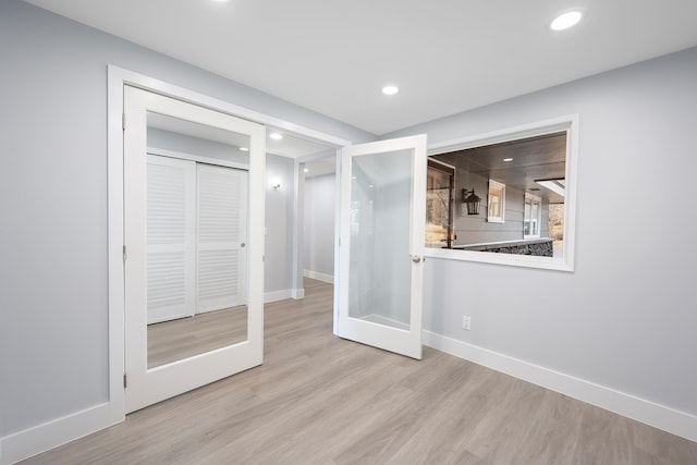 interior space with recessed lighting, french doors, baseboards, and wood finished floors