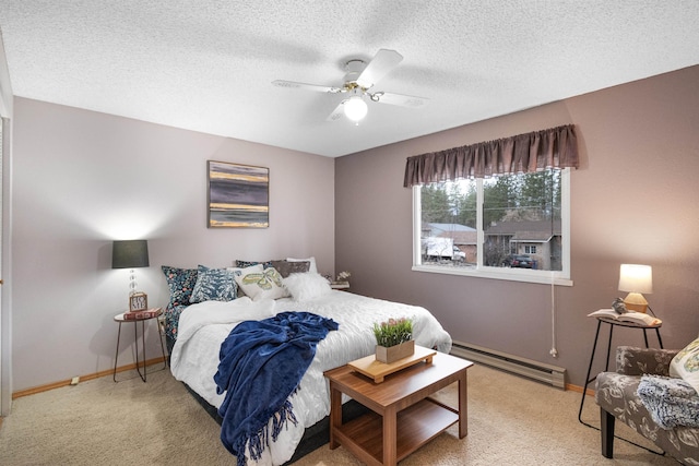 carpeted bedroom with a baseboard heating unit, a textured ceiling, baseboards, and a ceiling fan