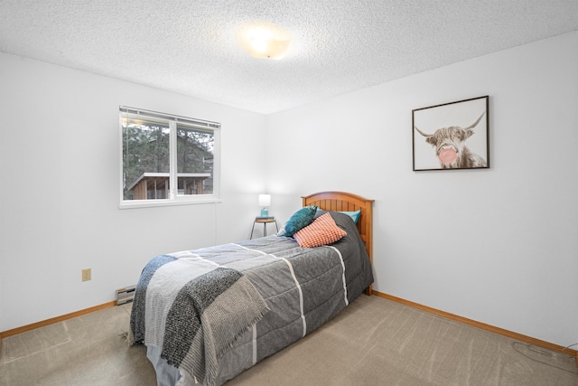 carpeted bedroom with a textured ceiling and baseboards