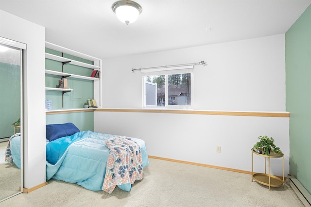 carpeted bedroom featuring baseboards and baseboard heating