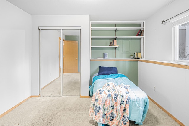 unfurnished bedroom featuring carpet floors, baseboards, and a closet