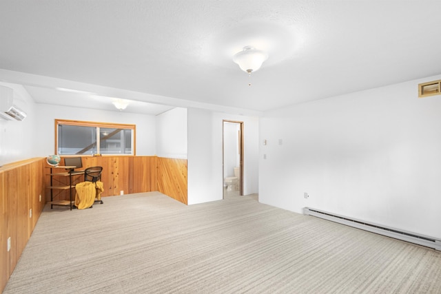 empty room with baseboard heating, a wall mounted AC, wainscoting, carpet flooring, and wood walls