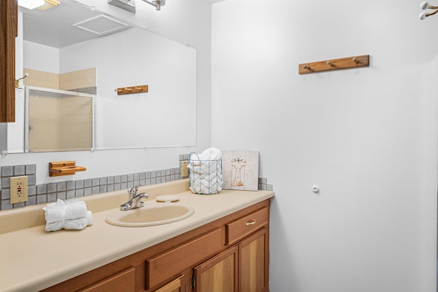 bathroom with a stall shower and vanity