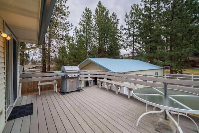 wooden terrace featuring a grill