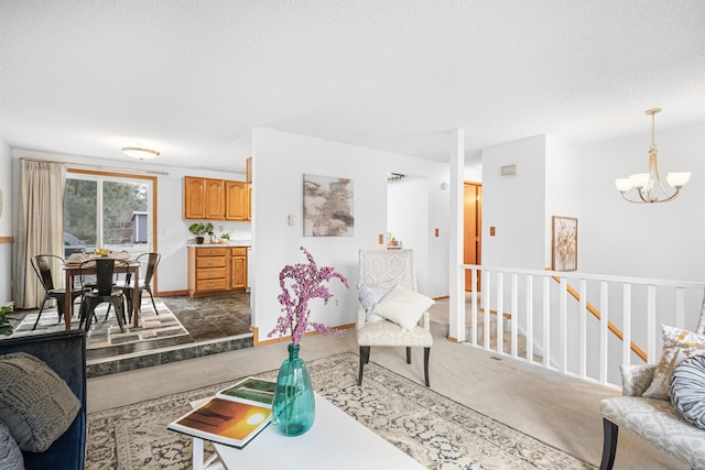 living area with a textured ceiling, dark carpet, baseboards, and a notable chandelier