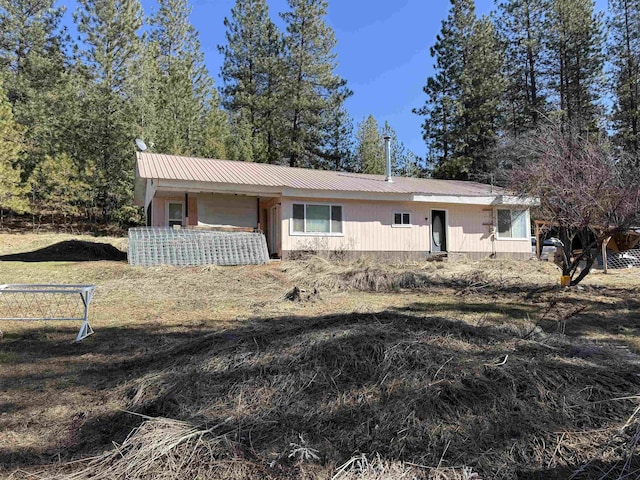 single story home featuring metal roof