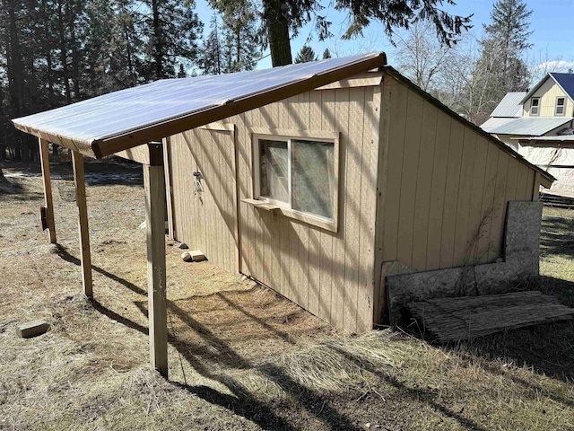 view of home's exterior with an outbuilding