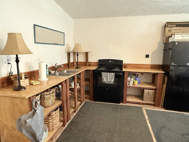 interior space with black appliances and a sink