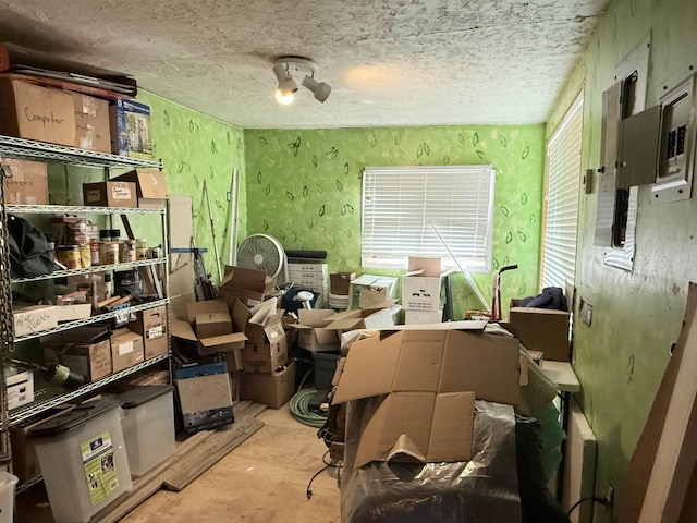 misc room featuring a textured ceiling and unfinished concrete floors