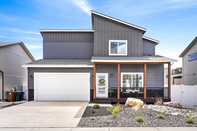 view of front of house with a porch, an attached garage, board and batten siding, fence, and driveway