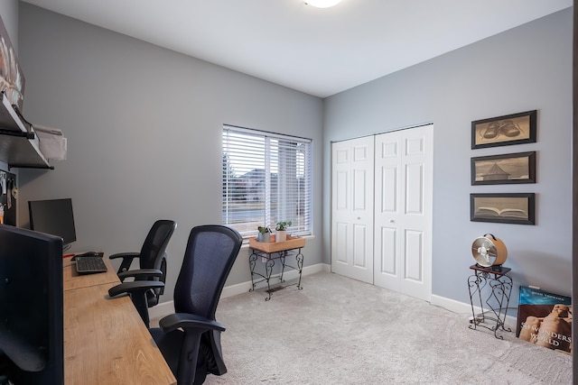 carpeted office featuring baseboards