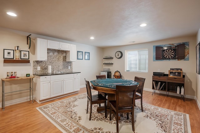 dining area with light wood finished floors, baseboards, and recessed lighting