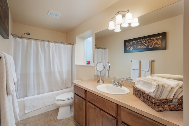 full bathroom featuring toilet, vanity, visible vents, and shower / tub combo with curtain