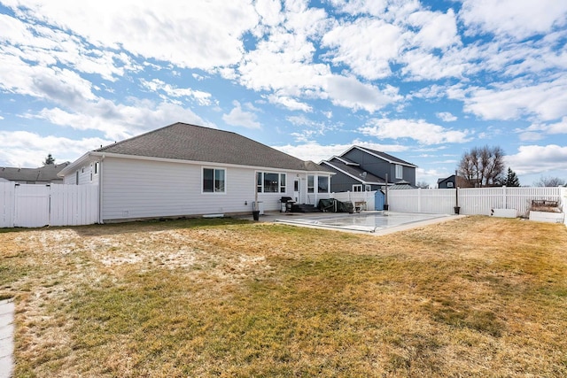 rear view of property featuring a fenced backyard, a gate, a lawn, and a patio