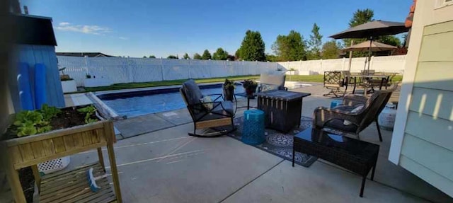 exterior space featuring a fenced backyard, outdoor dining area, and a fenced in pool