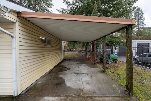 view of patio featuring a carport and fence