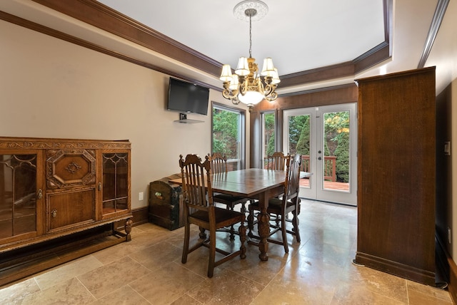 dining space with a notable chandelier, baseboards, and crown molding