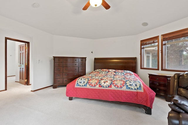 carpeted bedroom featuring ceiling fan and baseboards