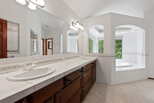 full bath with a bath, double vanity, a sink, and visible vents